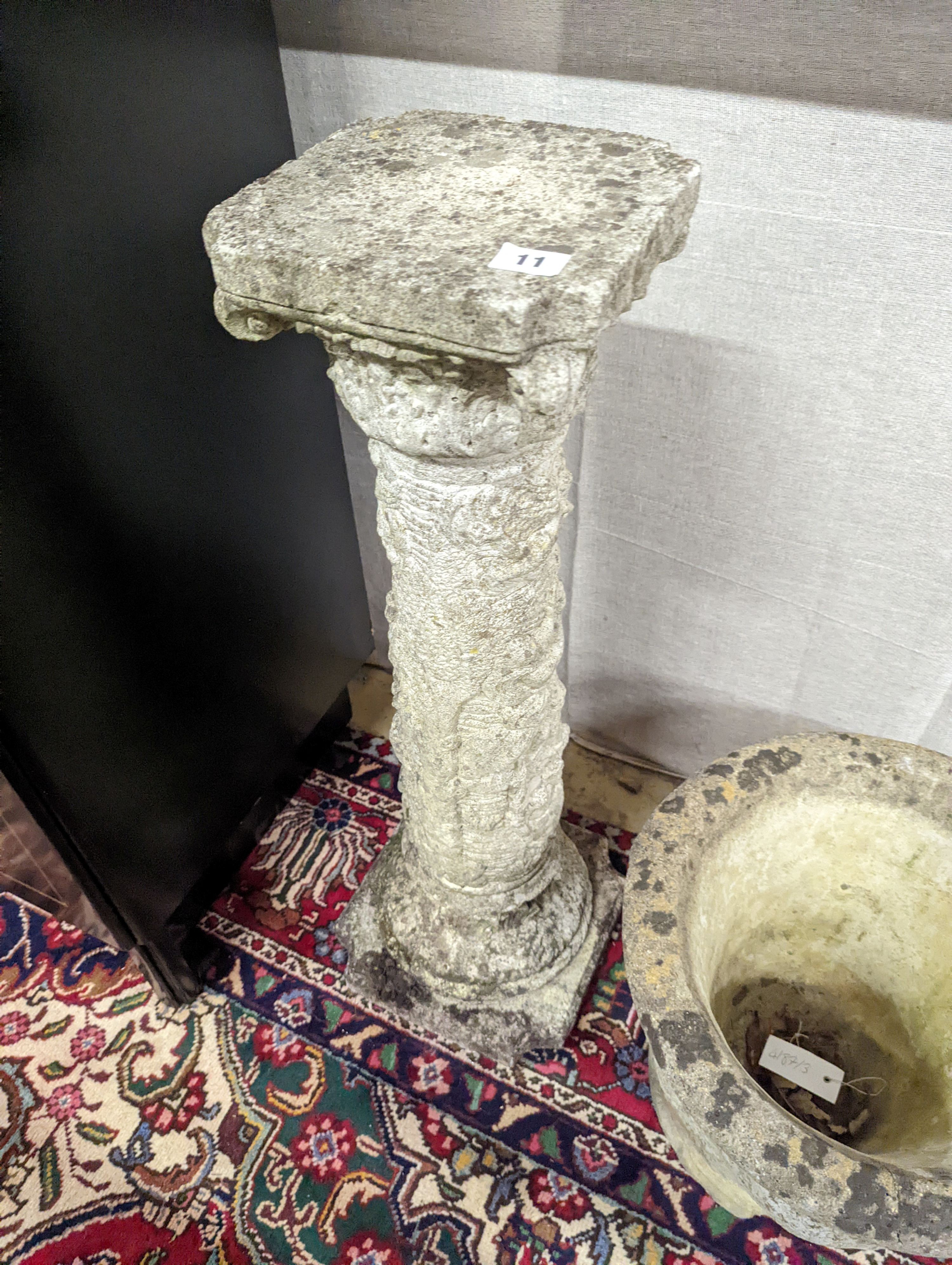 A reconstituted stone garden plinth, height 79cm, together with two circular garden planters, larger diameter 42cm